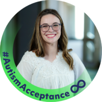 Headshot of Alex Clem, a white woman with long brunette hair and blue glasses, against a neon green circular frame with the text #AutismAcceptance and an infinity symbol.