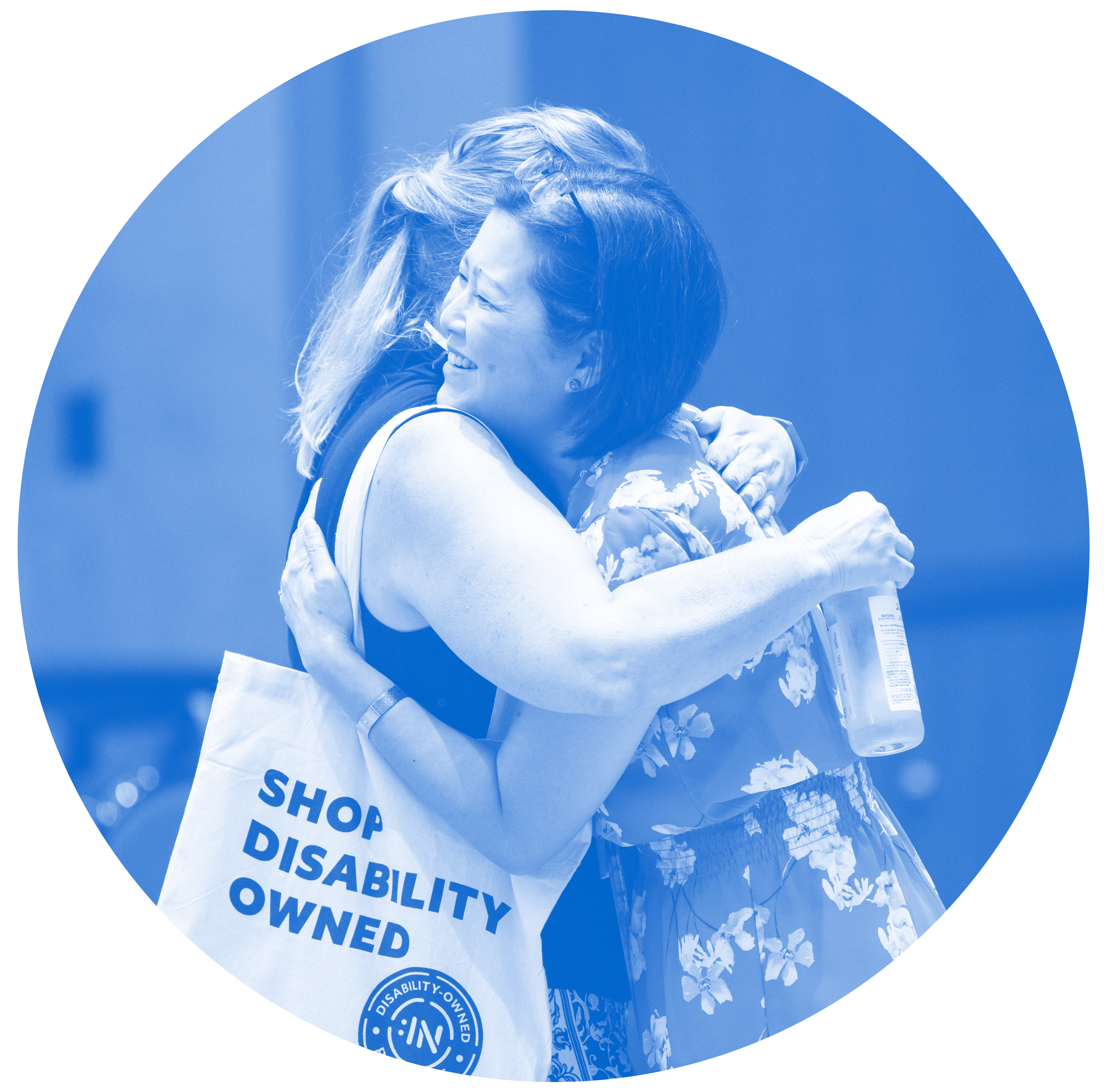 Two people embrace at the Disability:IN conference.