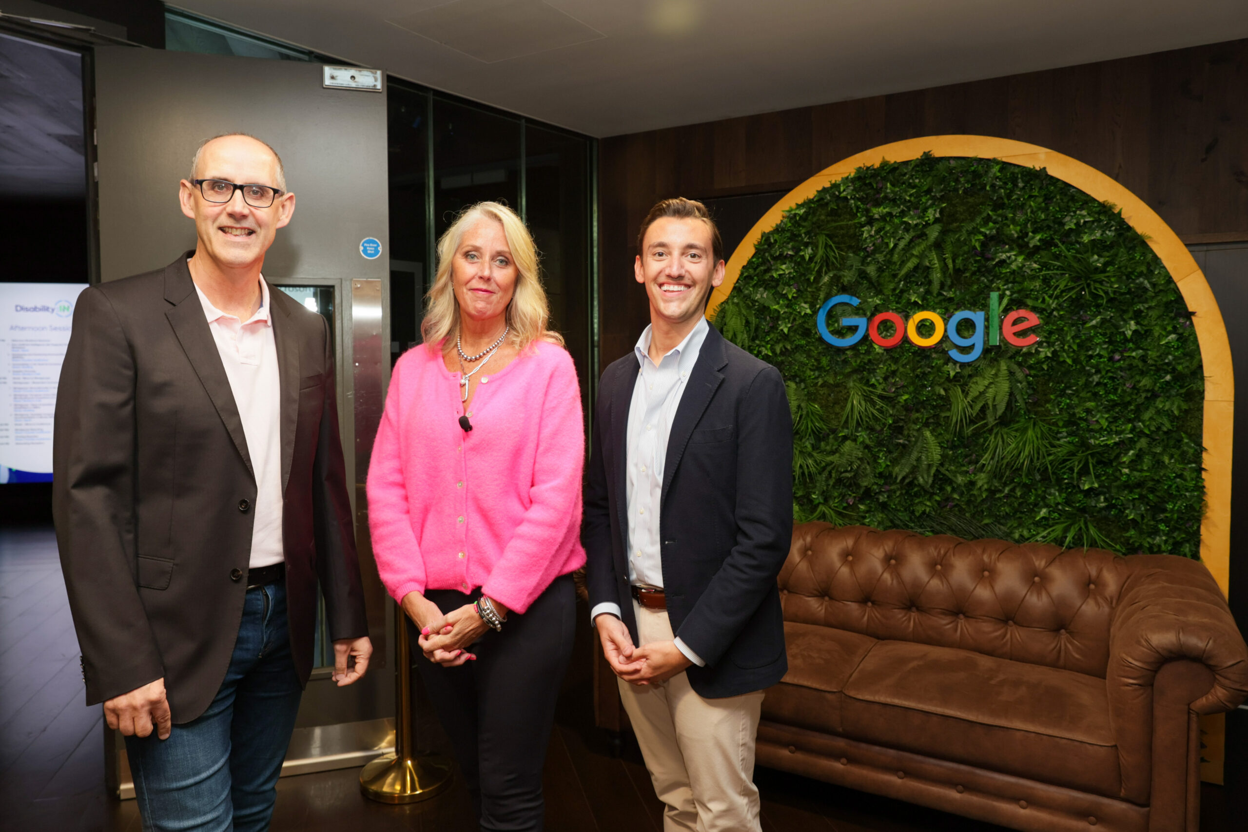 David Sneddon, Jill Houghton, and Brian Horn smiling in front of a Google Ireland wall installation.