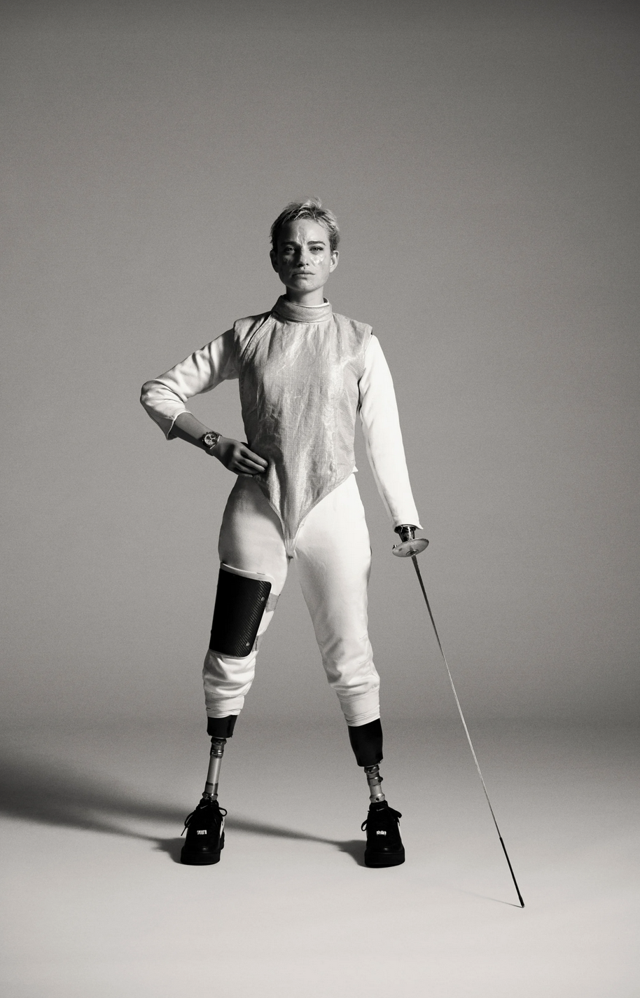 Bebe Vio, Italian fencer, wears prosthetics and poses with fencing gear.