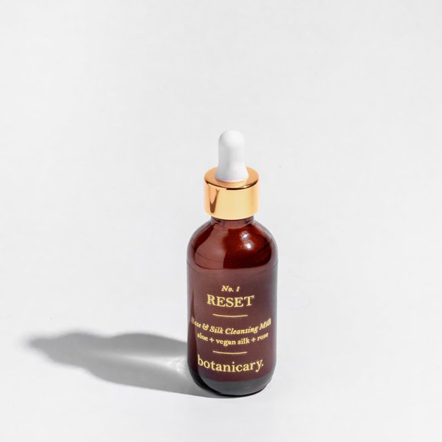 Botanicary No. 1 Reset Rose & Silk Cleansing Milk. Packaged in amber glass bottle with white and gold dropper.