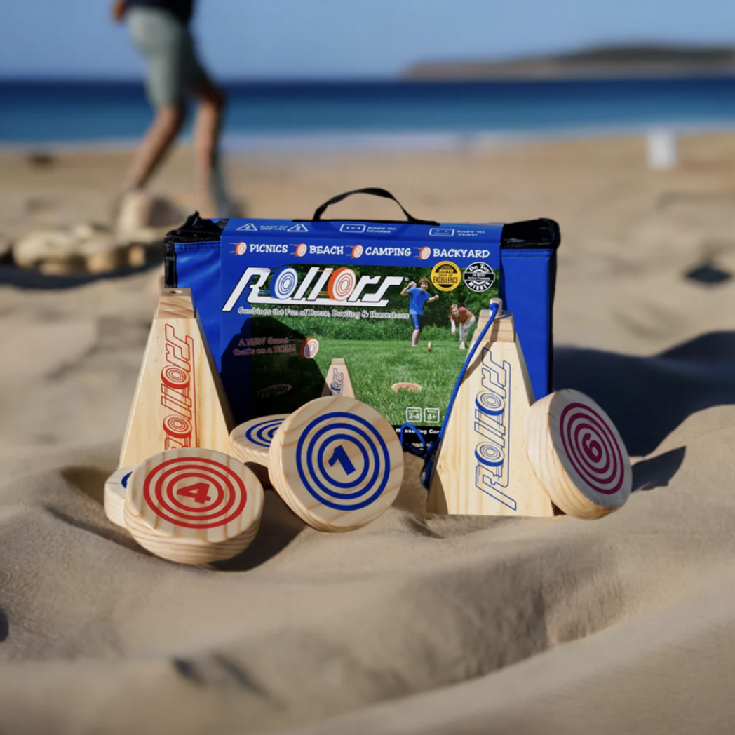 Rollors Outdoor Game pictured on a beach with people playing in the background.